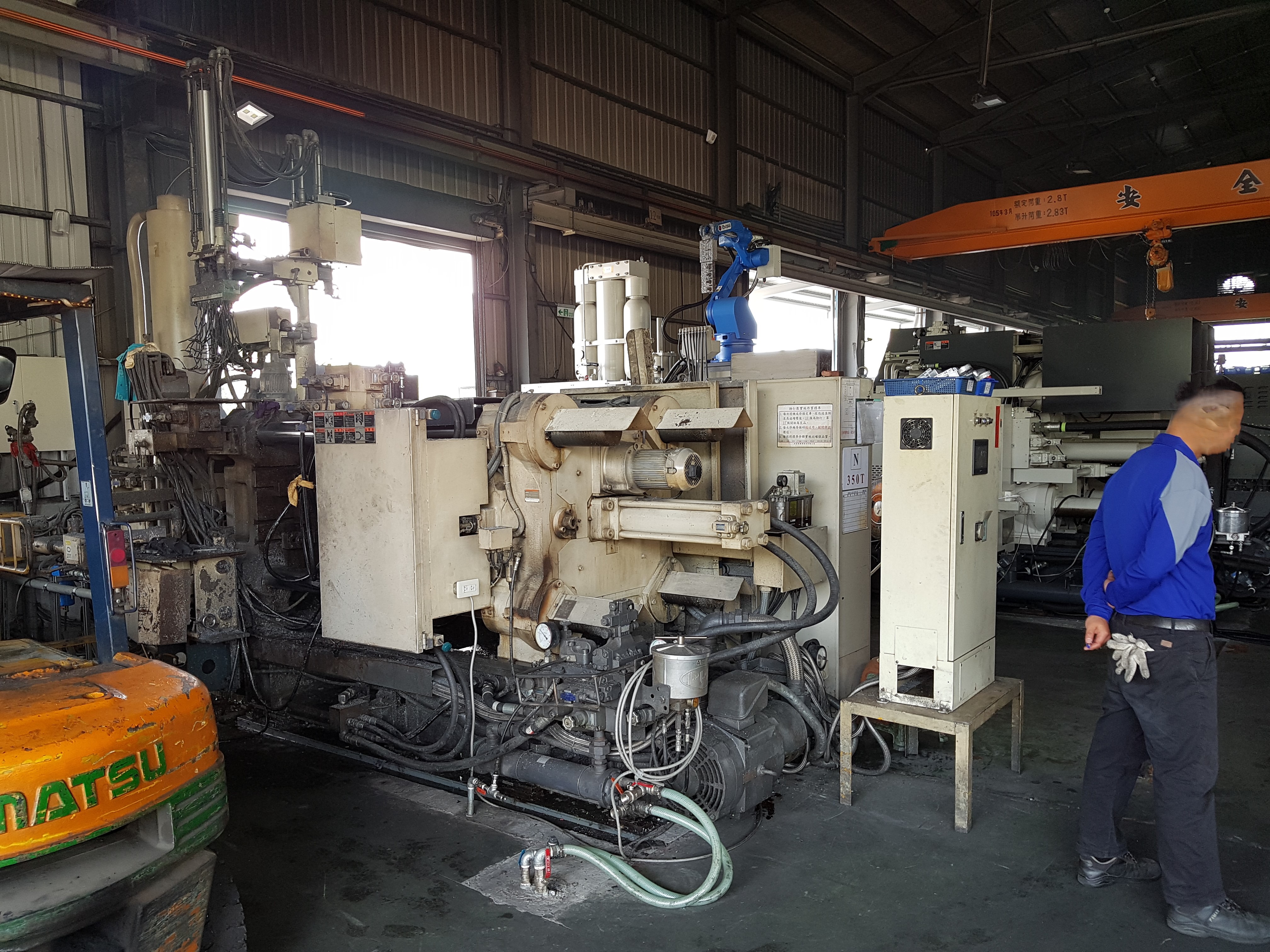 Large-scale injection moulding machine on a manufacturing shop floor